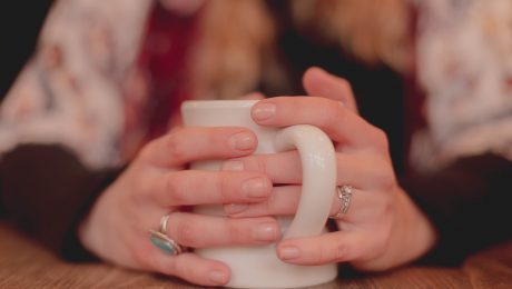 Hands holding a mug