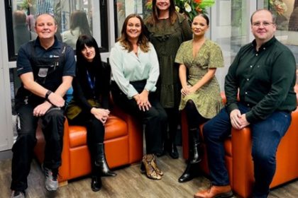 The BusinessLodge Stoke team photographed in a bright co-working space as they are recognised for Excellence in Customer Service