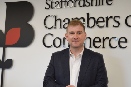 Chris Plant photographed in front of Staffordshire Chambers of Commerce's Logo
