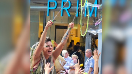 A women demonstrating how to make a bubble in front of Primark