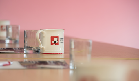 Staffordshire Chambers mug sat on a desk with other glasses for a meeting