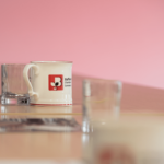 Staffordshire Chambers of Commerce's branded mug on a table with 3 glasses and other collateral in the background.