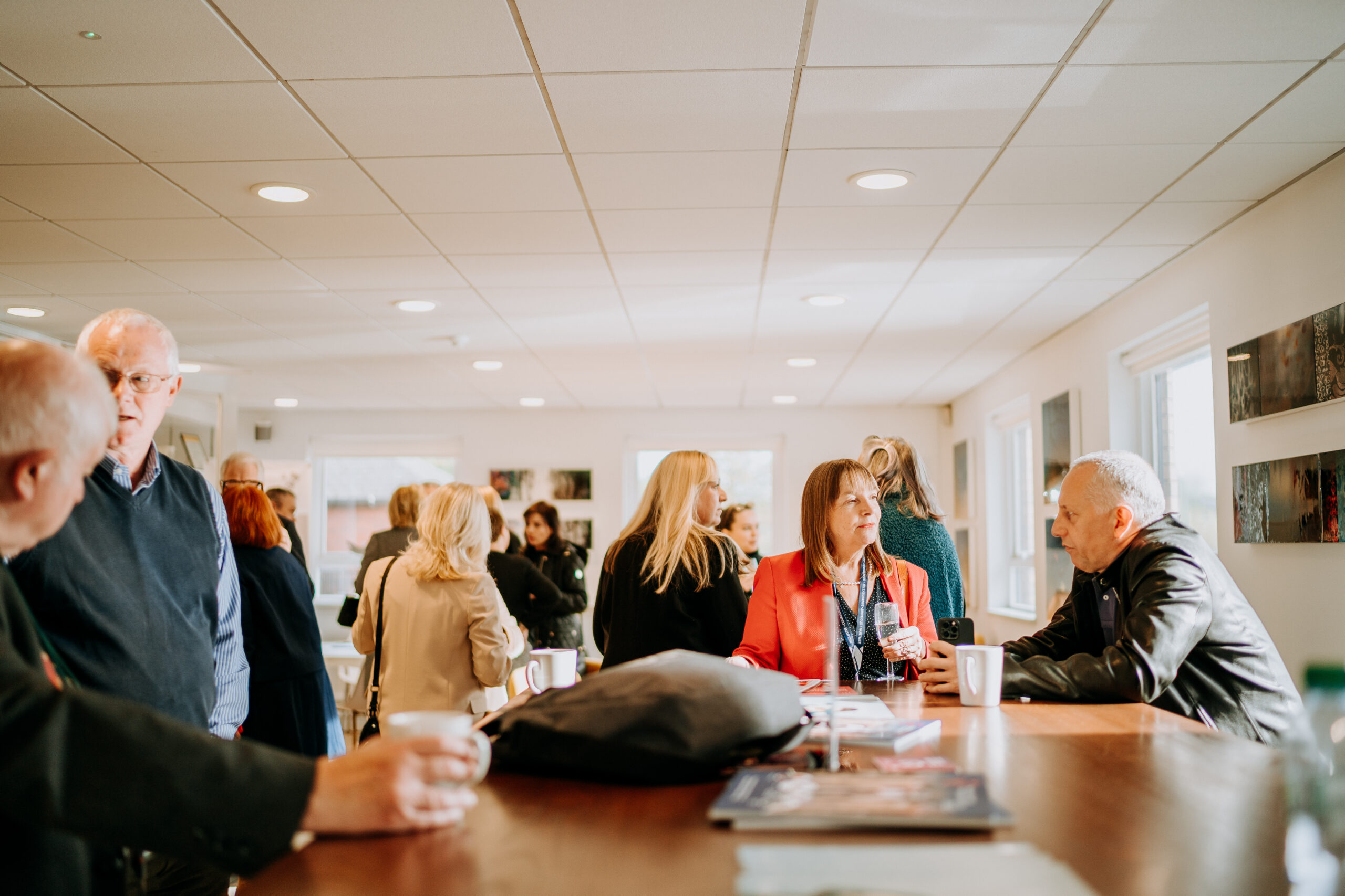 Staffordshire Chambers Members Lounge with people networking, having conversations, and enjoying refreshments in a bright and modern setting