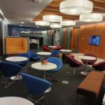 Stafford Chamber Members Lounge with a number of tables and chairs with a TV on the wall