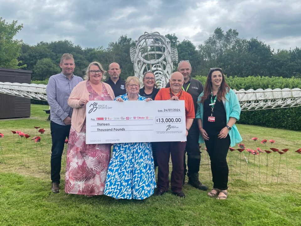 Knot a Sports Day organisers holding a cheque for £13,000