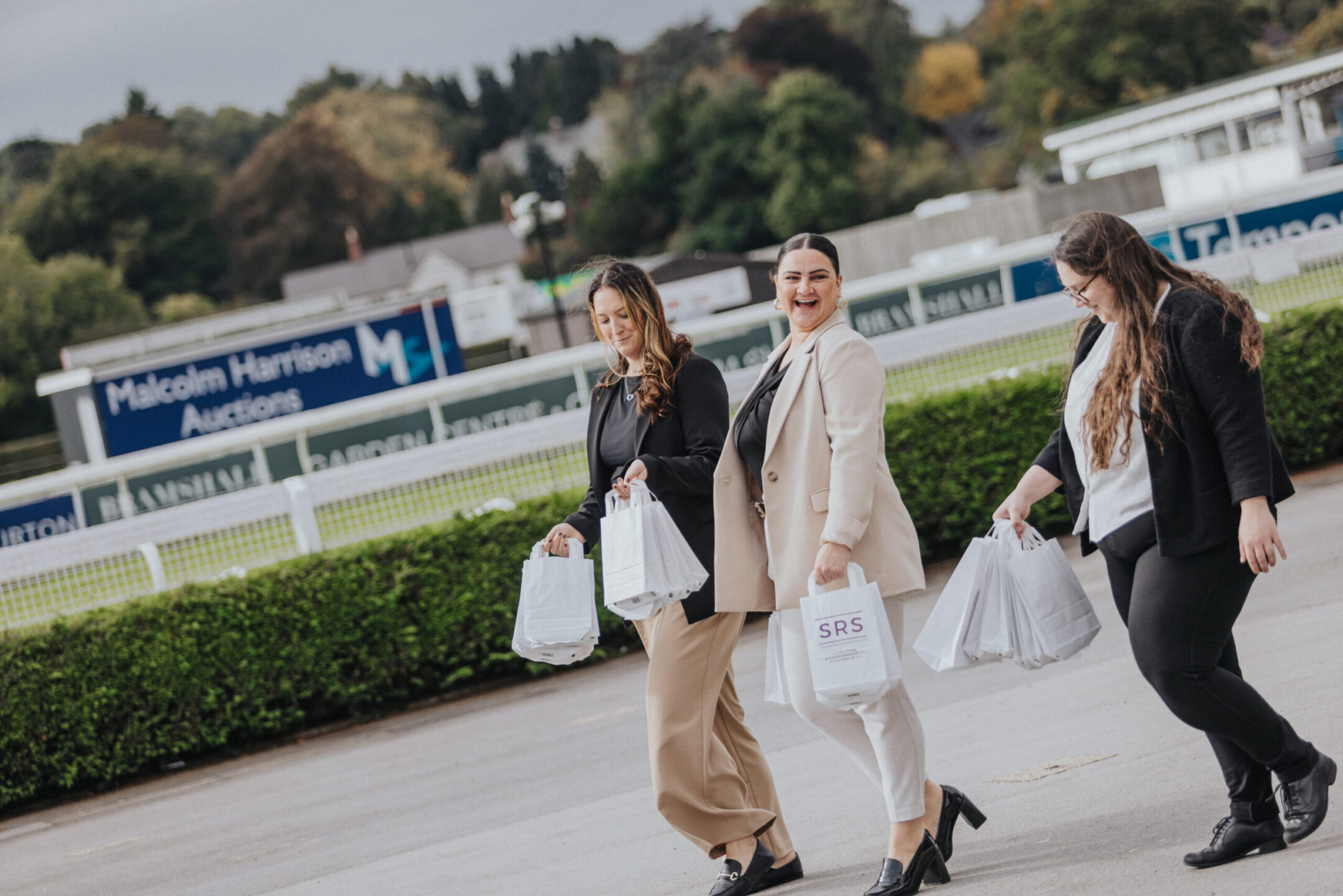 People at the lets do business 2025 expo event walking outside talking.