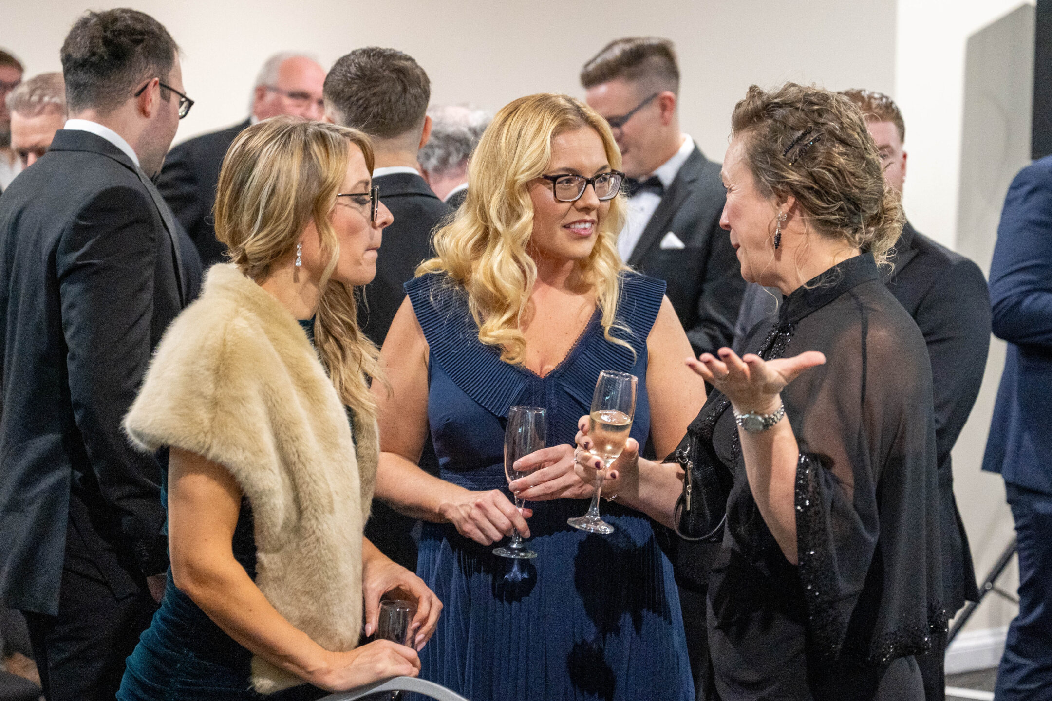 Picture of 3 people at a Staffordshire chambers of commerce event holding drinks.